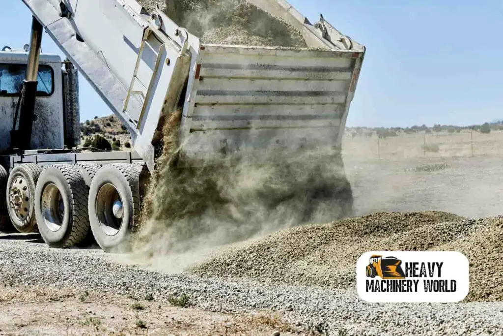 dump truck dropping a load of rock gravel